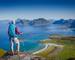Woman hiker enjoying at the top of the mountain and looking at incredible views of a Norwegian fjord, Lofotens. Travel, adve…
