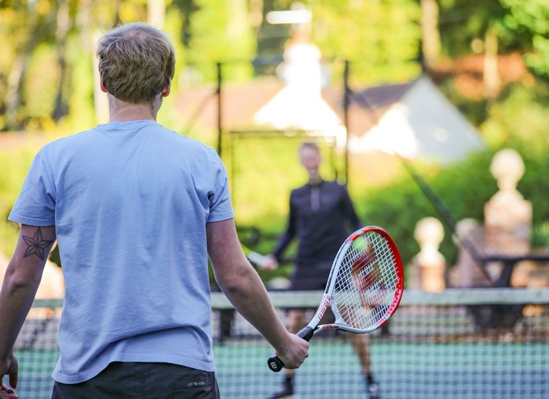 Two friends playing a game of tennis