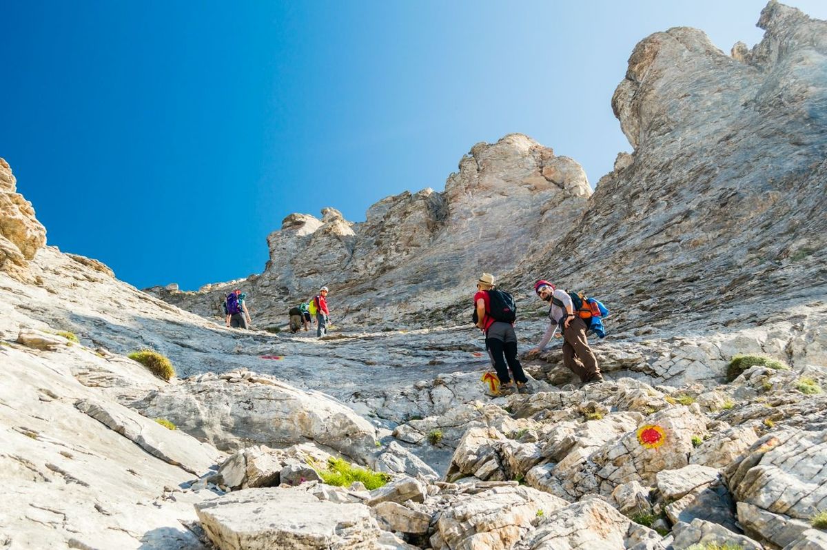 OLYMPUS NATIONAL PARK, GREECE - JULY 11, 2015: Tourists climbing the Olympus mountain in Greece.