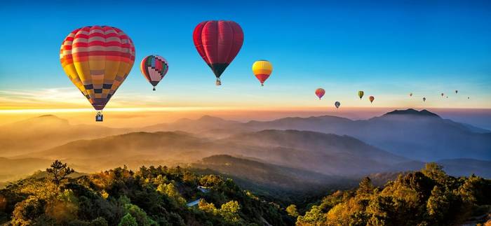Colorful hot air balloons over mountain at Dot Inthanon, Chiang Mai, Thailand shutterstock_1033306540.jpg