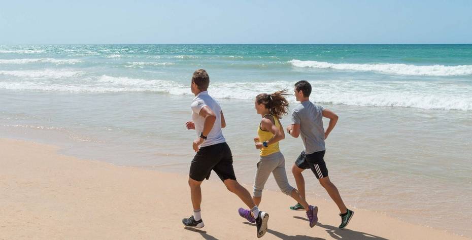 People running on the beach in Portugal