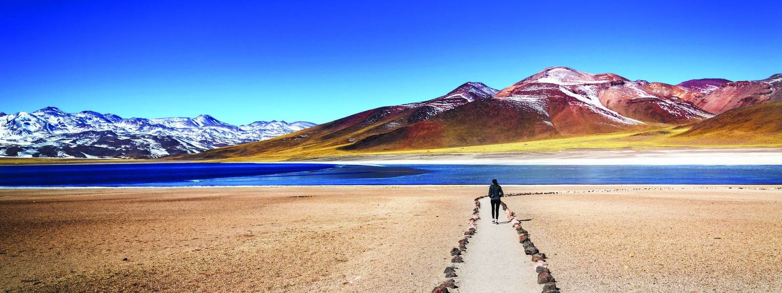 Tourist enjoying the beautiful landscape of Atacama Desert in Chile. Winter time.