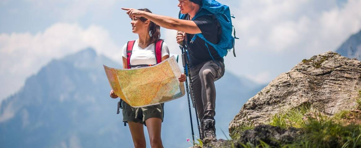 Hikers using map to navigate outdoors