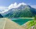 Dam and azure mountain lake  on the background of the high peaks of the Alps, Zillertal, Austria