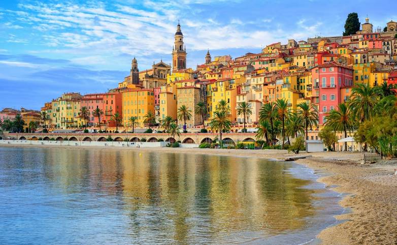 Sand beach beneath the colorful old town Menton on french Riviera, France