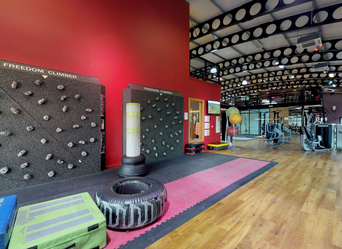 Climbing wall and other gym equipment inside large Hampshire Health Club