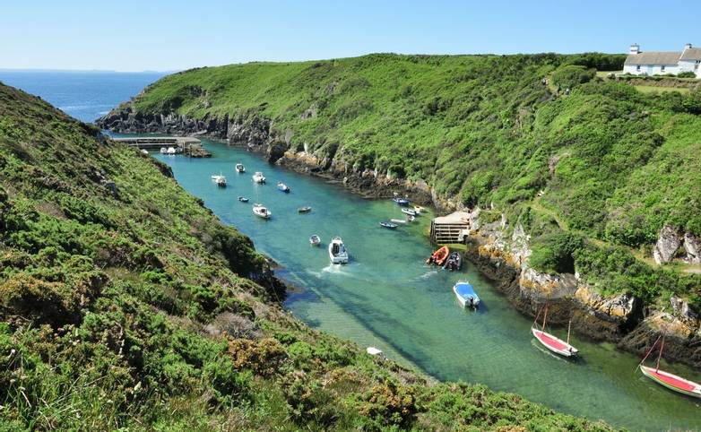 Various boats in the small sheltered harbour at Porthclais, Pembrokeshire, Wales
