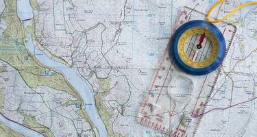 A map of the Derwent Reservoir in the Peak District, UK, with a compass laying on top of it