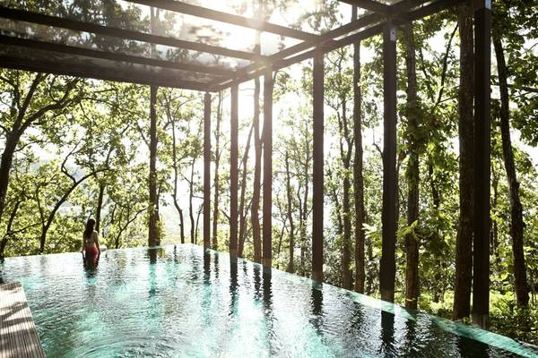 Woman in the swimming pool at Ananda in the Himalayas in India