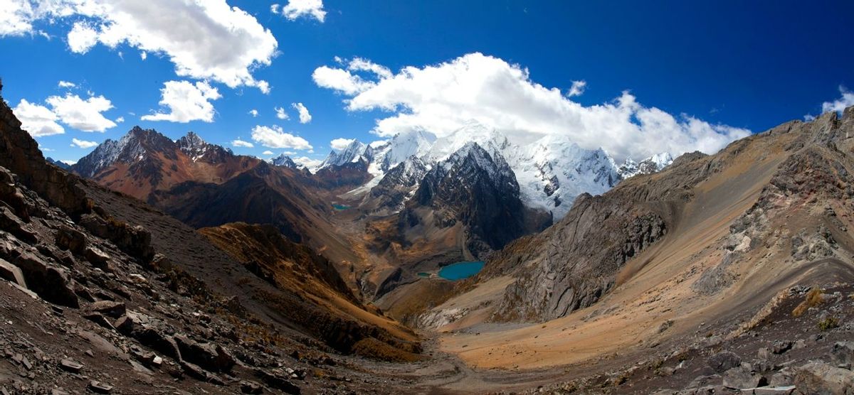 Panorama of snowy mountains and valley in the remote Cordillera Huayhuash Circuit near Caraz in Peru.