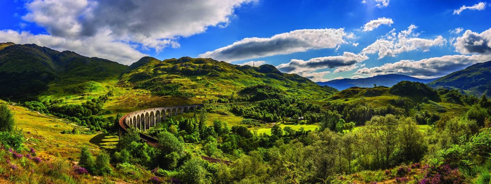 Panorama of Glenfinnan Railway Viaduct in Scotland and surrounding mountains
