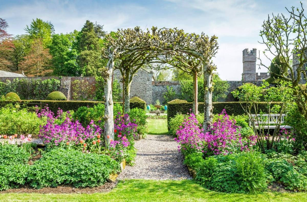 Trellis and flower beds in gardens on grounds of Hutton in the Forest in Cumbria, England.