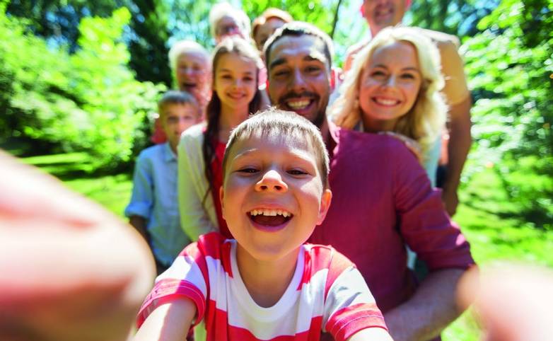 happy family taking selfie in summer garden