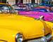 HAVANA, CUBA - JULY 8, 2016. Colorful vintage classic American cars, commonly used as private taxi parked in Havana street.