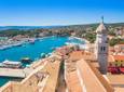 Aerial view of the old town of Krk in Croatia, cathedral tower and marina in background