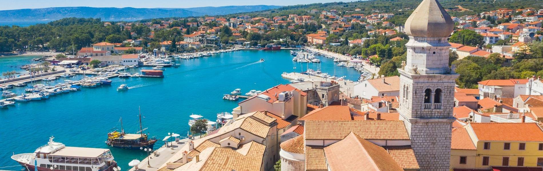 Aerial view of the old town of Krk in Croatia, cathedral tower and marina in background