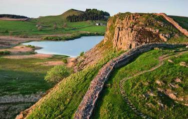 Stunning landscape image of Hadrian's Wall in Northumberland at sunset with fantastic late Spring light