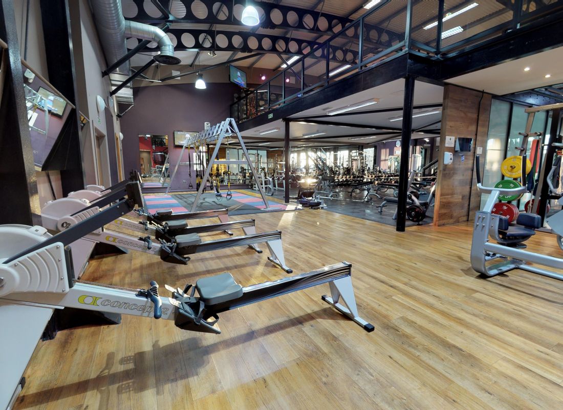 Rowing machines lined up against health club wall