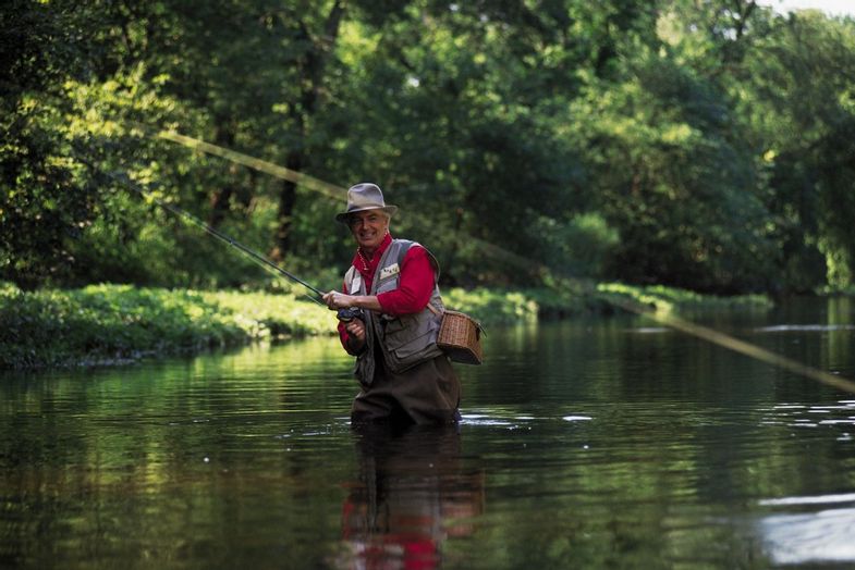 Mature man fly-fishing