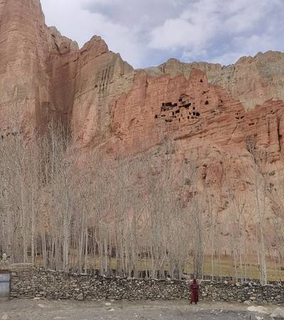 Towering red cliffs and caves near Dhakmar village