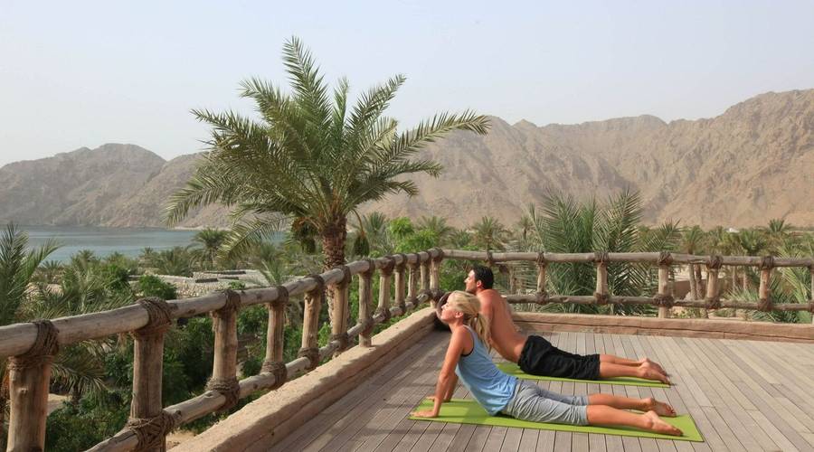 Couples yoga at Six Senses Zighy Bay