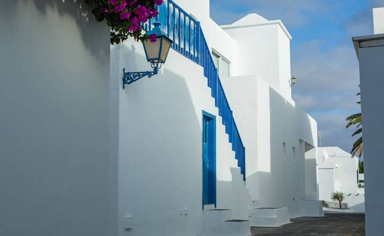 Beautiful white two-story houses for holidaymakers in Costa Teguise on Lanzarote island. Route to the ocean.