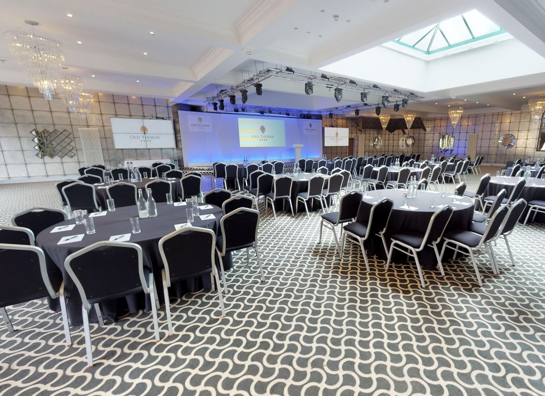 Conference meeting being held in large ballroom using av equipment