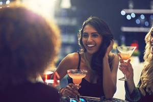 Shot of a group of friends relaxing with cocktails in a nightclub.