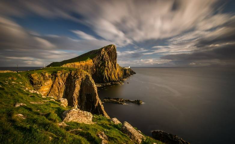 Neist Point cliffs and lighthouse in sunset light, Isle of Skye, Scotland
