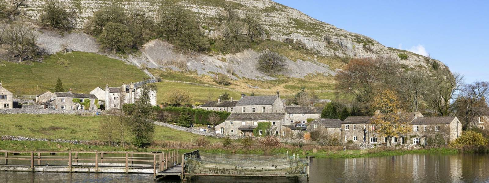 kilnsey crag village and fishing lake in wharfedale north yorkshire on sunny day