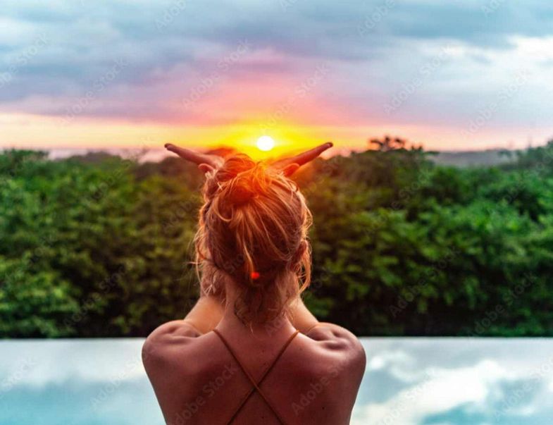 Wellness & Wisdom Journeys Woman sun salutation at sunrise costa rica-elisa-adobe stock.jpg