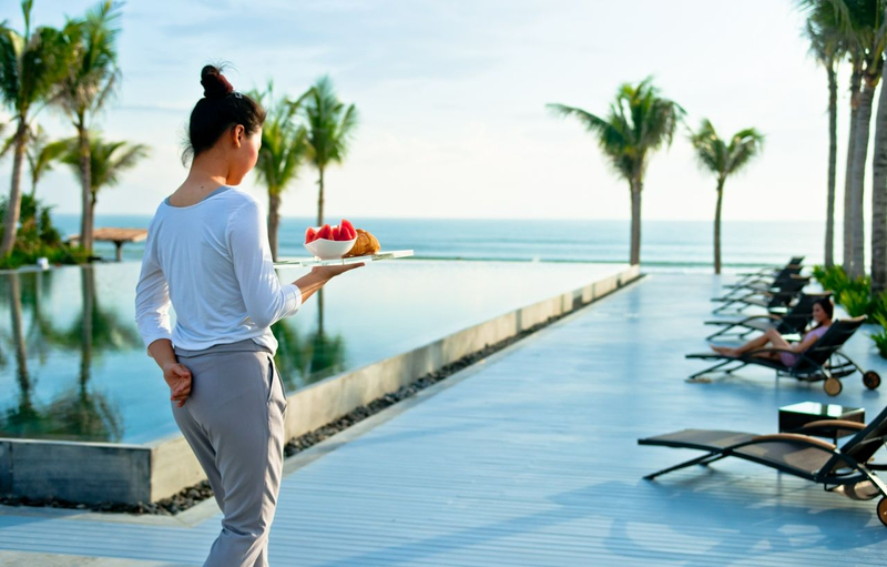 A women holding bowl of fruits walking