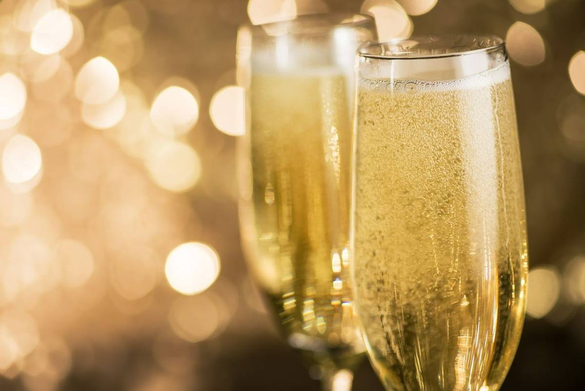 Closeup of two champagne glass on a bokeh light background. Happy celebration of New Year.
