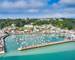 Airial drone image of St Aubn's Harbour and Village at high tide in the sunshine. Jersey Channel Islands