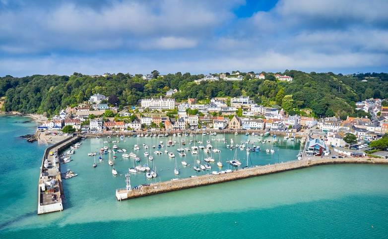 Airial drone image of St Aubn's Harbour and Village at high tide in the sunshine. Jersey Channel Islands