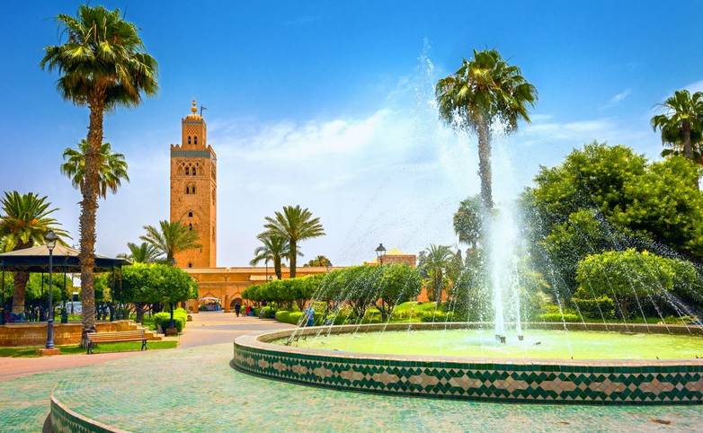 Scenic view from garden with fountain of minaret of Koutoubia Mosque in Marrakech. Morocco, North Africa