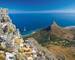Table Mountain cable car ascending to top station with Robben Island in the background