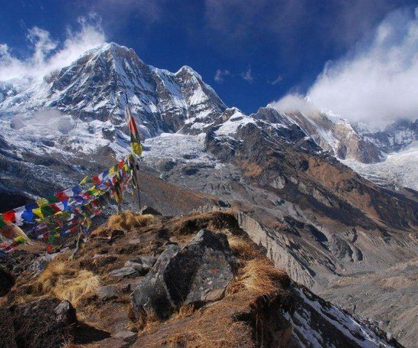 A rocky outcrop with colourful prayer flags along the Annapurna Circuit