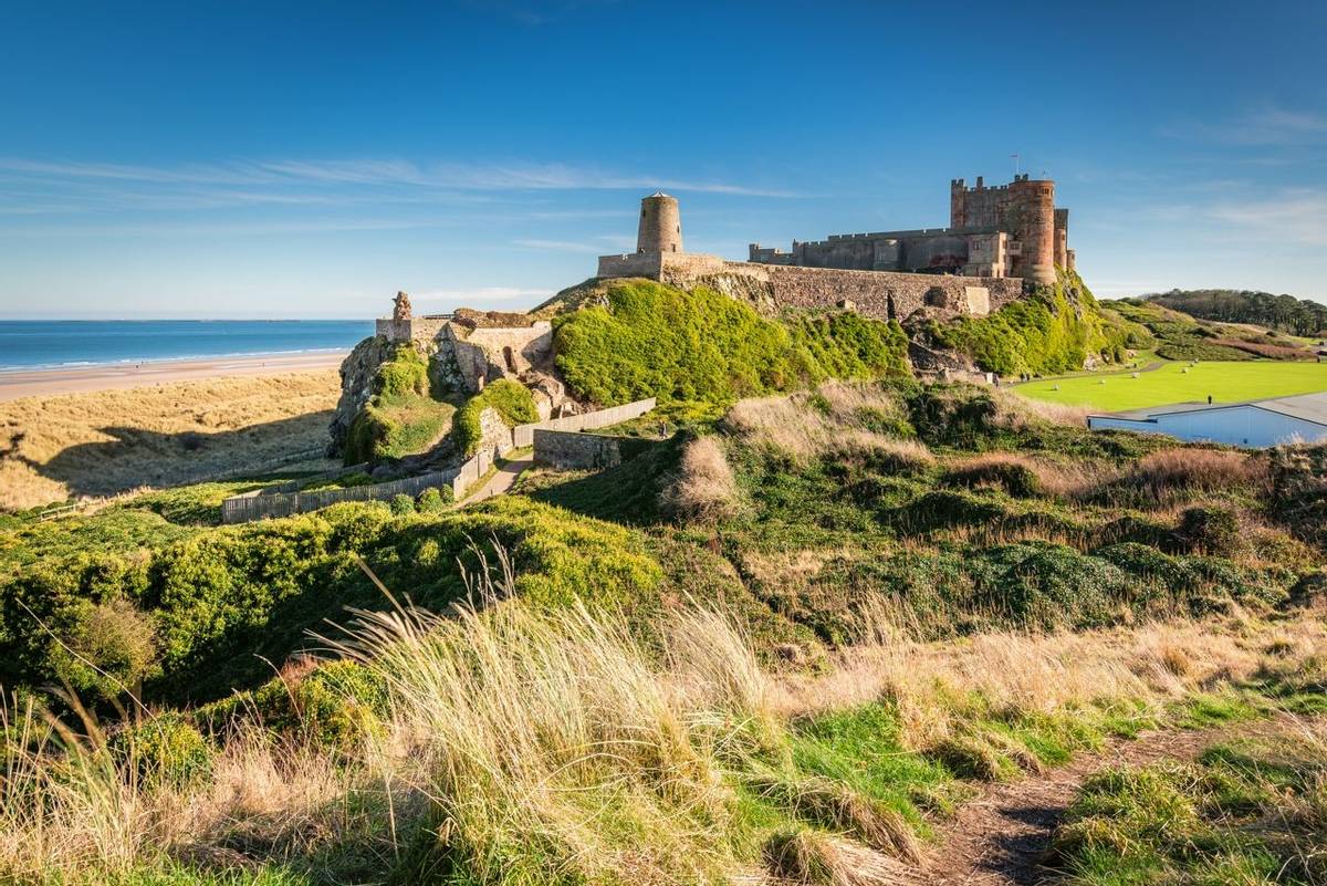 Bamburgh Castle viewed from an elevated hillock, on the Northumberland coastline