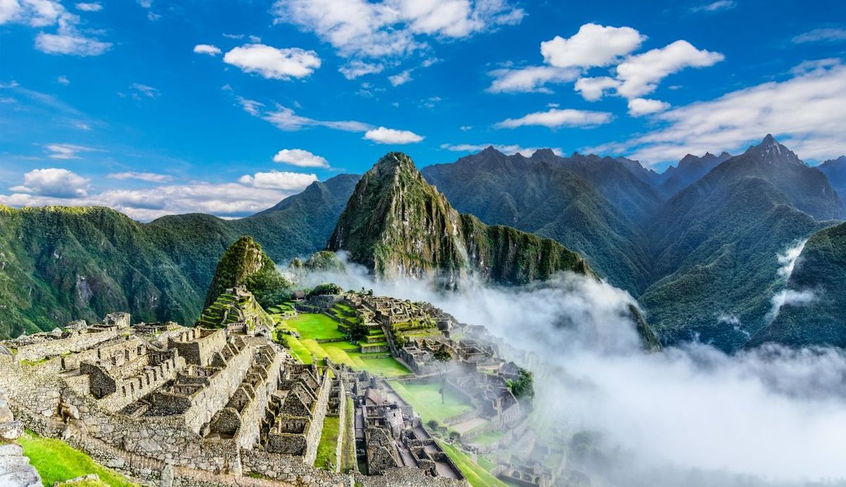 Overview of Machu Picchu, agriculture terraces, Wayna Picchu and surrounding mountains in the background