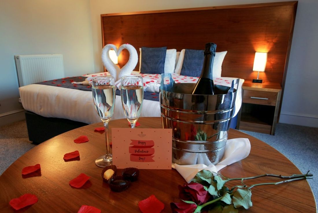 Valentines break package decorations include rose petals, chocolates and Prosecco