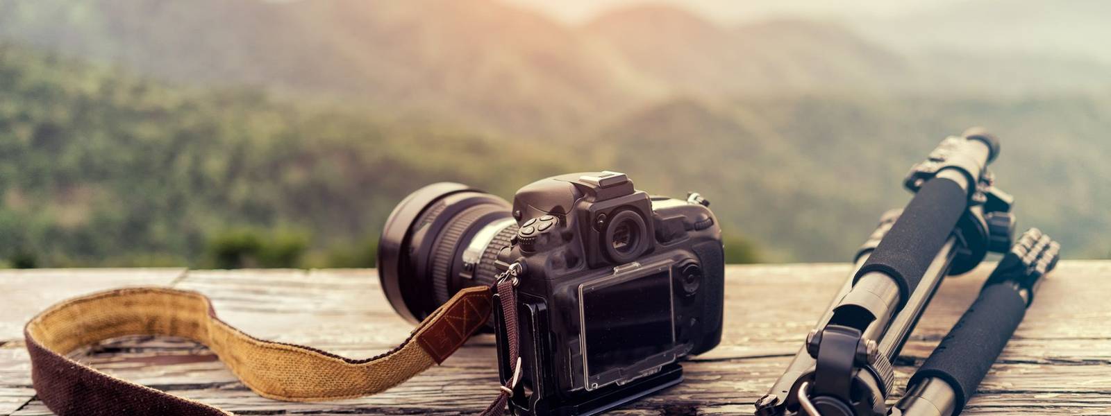 Travel photographer equipment with beautiful landscape on the background, Traveling and Relax Concept.