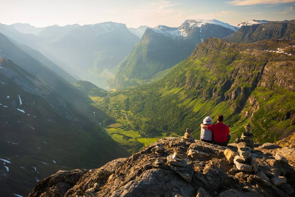 Dalsnibba, Norway, June 25, 2023: A couple takes in the view from Europe's highest fjord viewpoint by road, overlooking the …