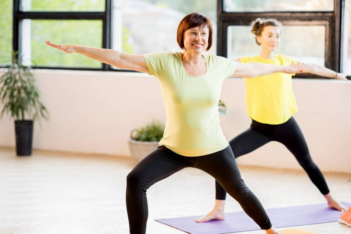 Young and older women doing yoga