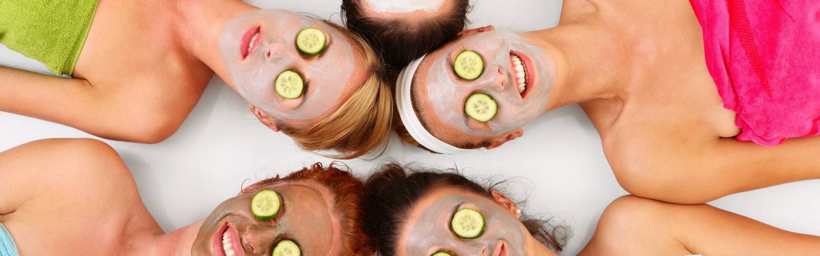 16537352 - a picture of five girl friends relaxing with facial masks on over white background
