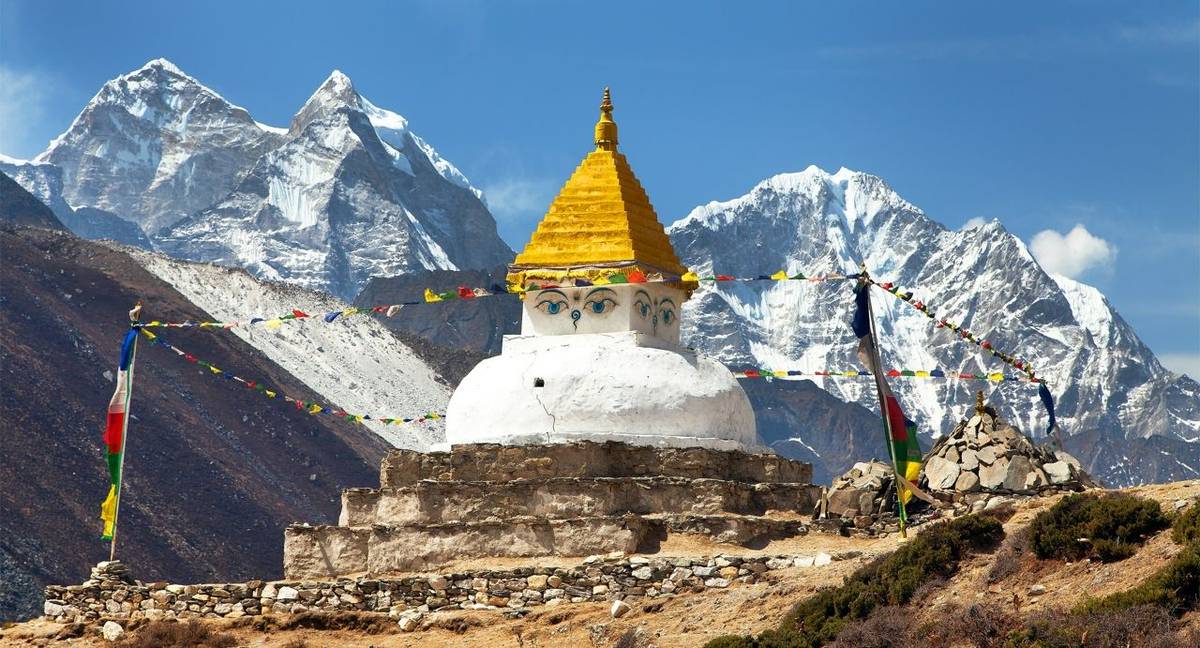 Stupa near Dingboche village with prayer flags and mounts Kangtega and Thamserku - way to mount Everest base camp - Khumbu v…