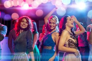 party, holidays, celebration, nightlife and people concept - smiling friends dancing in club