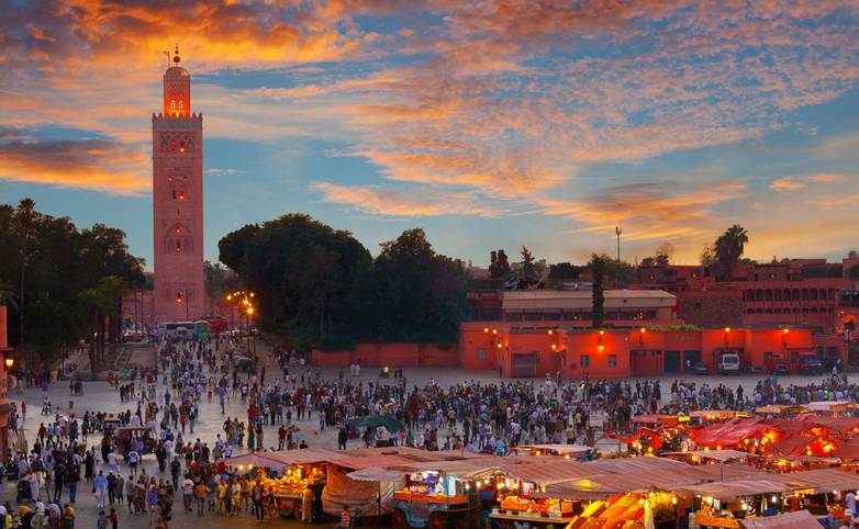 Famous Jemaa el Fna square crowded at dusk. Marrakesh, Morocco