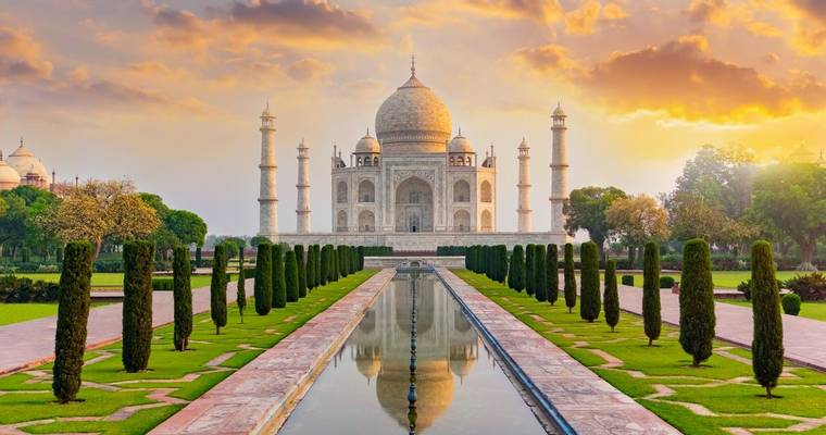 Taj Mahal front view reflected on the reflection pool, an ivory-white marble mausoleum on the south bank of the Yamuna river…