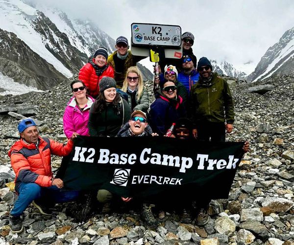 A group of hikers celebrating after reaching K2 Base Camp